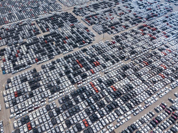 Aerial view of cars parked on parking lot during sunny day