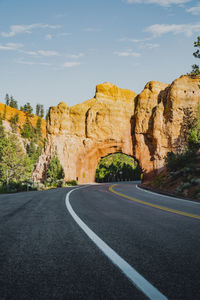 Road by mountain against sky