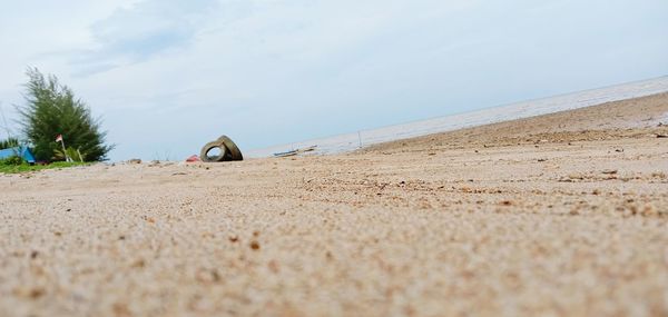 Surface level of sandy beach against sky