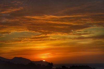 Scenic view of dramatic sky during sunset