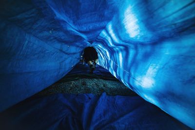 Low angle view of man standing in tunnel