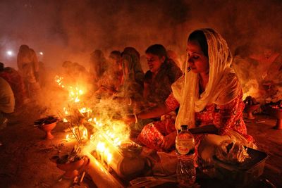 Women praying at rakher upobash barodi lokhnath brahmachari ashram