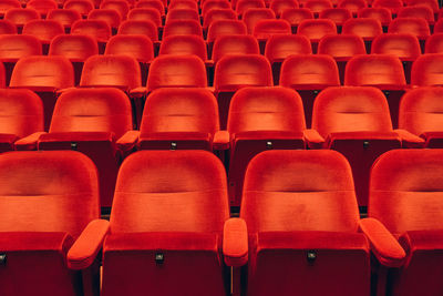 Empty red chairs in auditorium