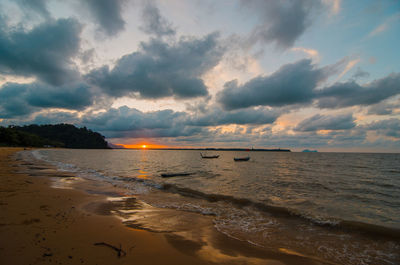 Scenic view of beach against sky during sunset