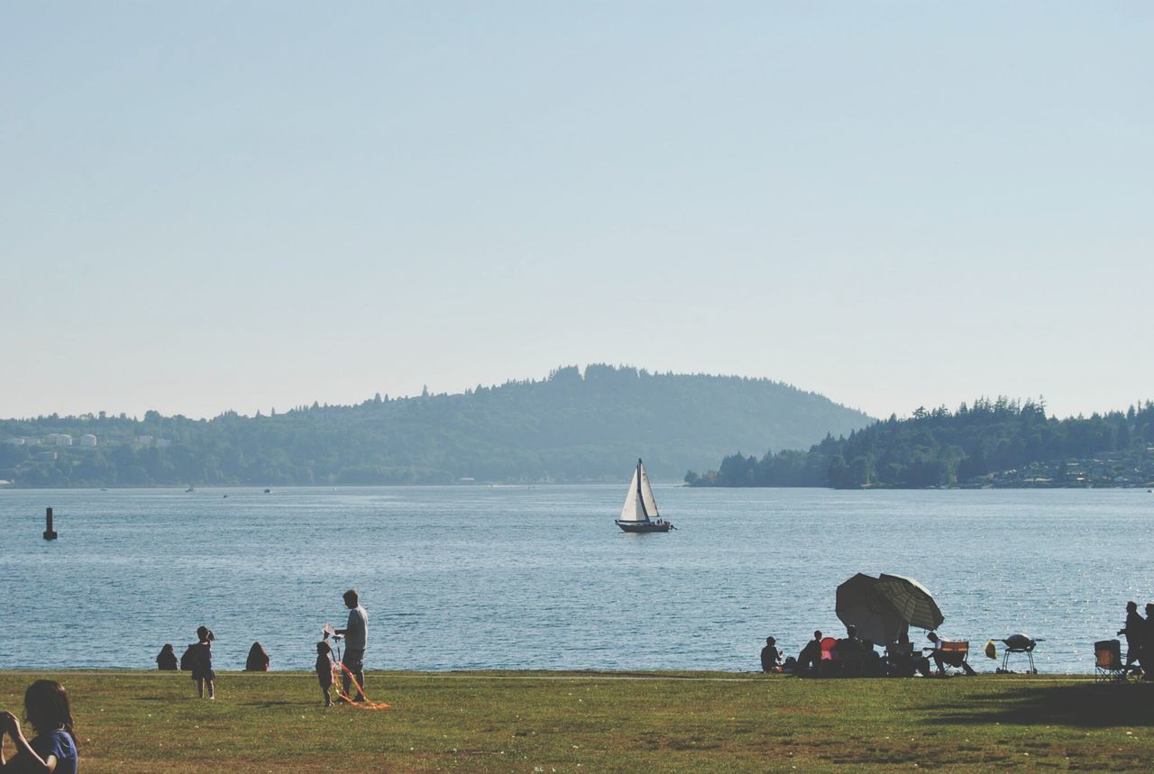 water, lifestyles, leisure activity, men, clear sky, copy space, nautical vessel, person, sea, transportation, sitting, large group of people, togetherness, vacations, mode of transport, relaxation, nature, scenics, tranquility