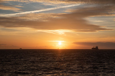 Ships sailing in the mediterranean sea with a sunset