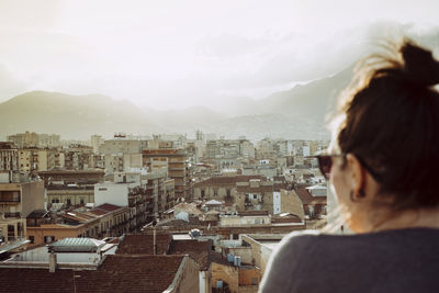 Rear view of woman looking at cityscape