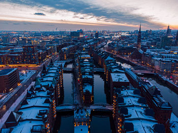 High angle view of illuminated buildings against sky during sunset