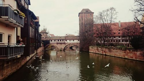 Bridge over river with buildings in background