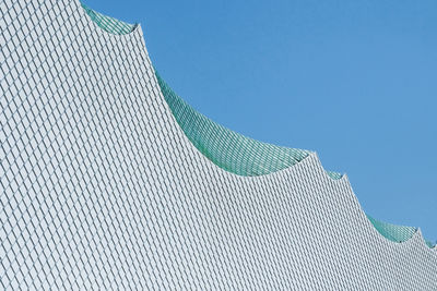 Low angle view of white modern building against clear blue sky