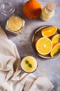 Diet orange smoothie with rice milk in a glass on the table top and vertical view