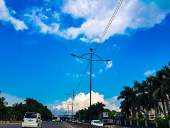 Low angle view of cars on road against sky