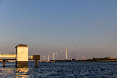 Beautiful windmills in the port of rotterdam. beautiful sunset on the sea coast.