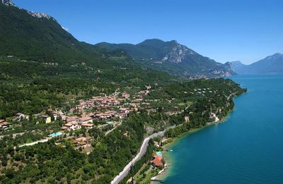 High angle view of townscape by lake garda against sky