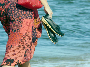 Midsection of woman wading in sea