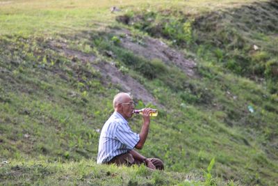 Man sitting on field