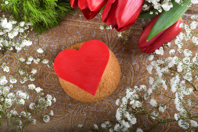 Close-up of red rose on heart shape