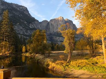 Scenic view of lake by trees against sky during autumn