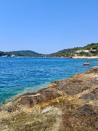 Scenic view of sea against clear blue sky