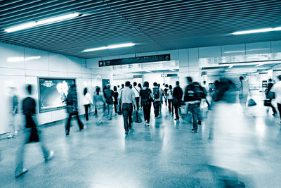 Group of people walking in subway station