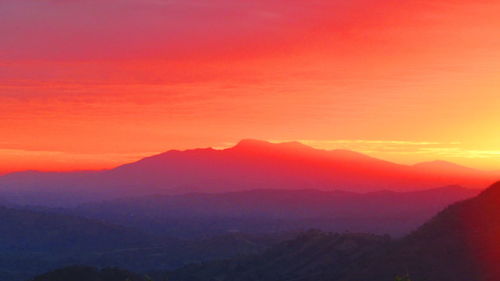 Silhouette of mountain against sky at sunset