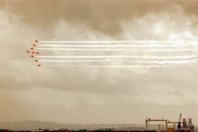 Low angle view of airshow against sky