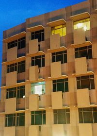 Low angle view of residential building against clear blue sky