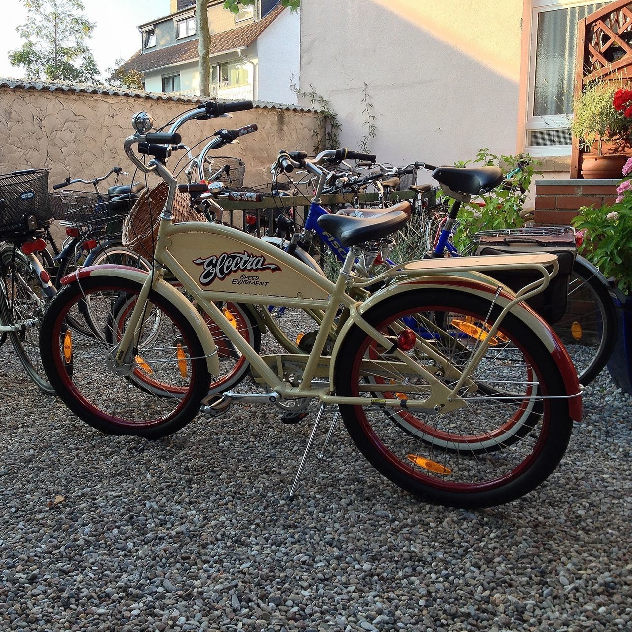 transportation, bicycle, mode of transport, land vehicle, stationary, parked, parking, building exterior, architecture, built structure, street, wheel, car, day, outdoors, no people, city, sidewalk, wall - building feature, house