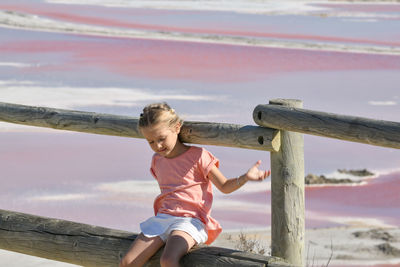 A girl at the salin-de-giraud salt farm with pink salty water