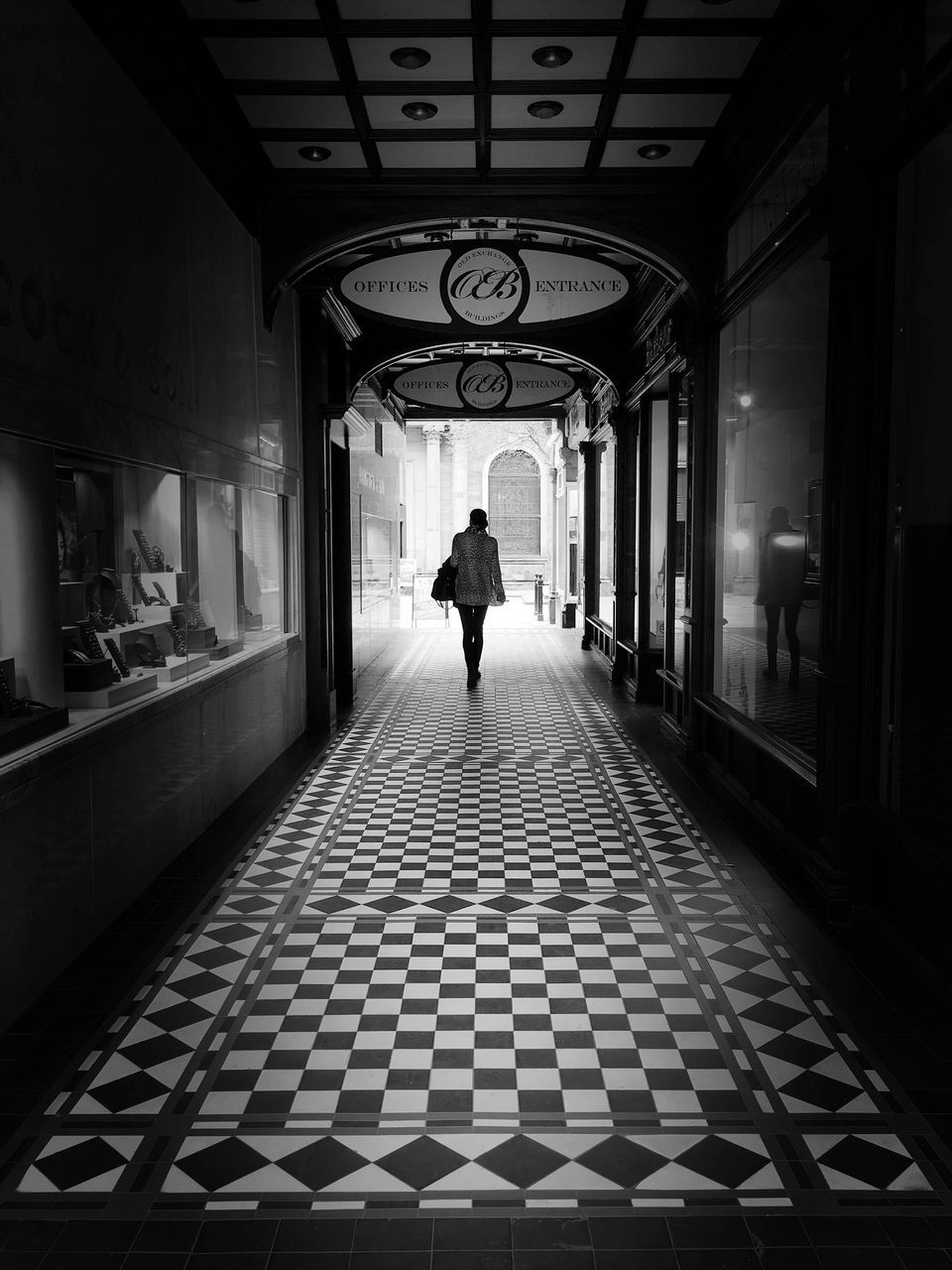 indoors, full length, walking, rear view, men, architecture, lifestyles, the way forward, built structure, corridor, person, ceiling, diminishing perspective, leisure activity, flooring, silhouette, tiled floor, day