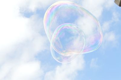 Low angle view of bubbles against sky