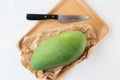 High angle view of lemon slice on cutting board against white background