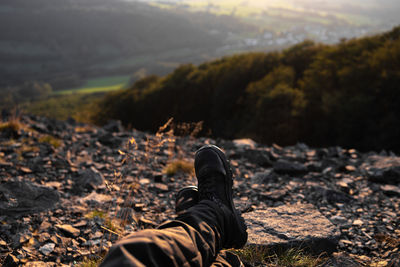 Low section of woman sitting on mountain