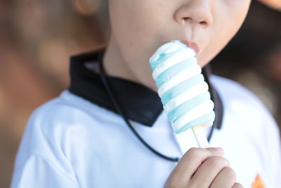 Close-up of boy eating ice cream