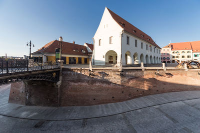 Buildings in city against clear sky