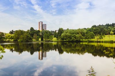 Scenic view of lake by trees against sky