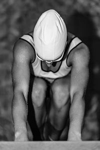 Female swimmer in the water on poolside