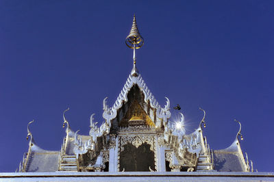 Low angle view of traditional building against blue sky