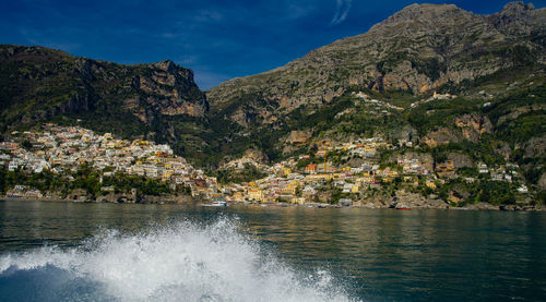 Scenic view of sea and mountains against sky