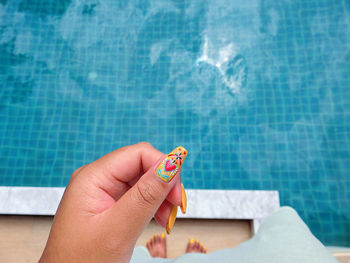 Woman holding hands in swimming pool