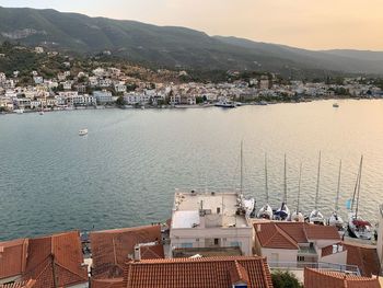 High angle view of townscape by sea against sky