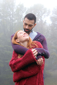 Young couple standing in park during winter