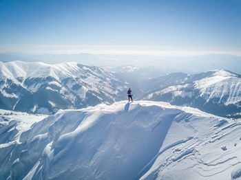 Man standing on snowcapped mountain