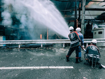 People working on street in city