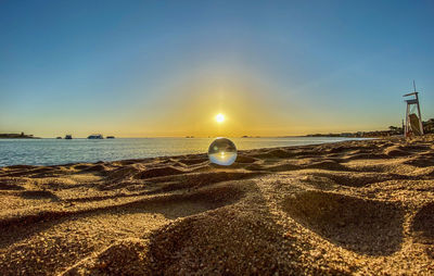 Scenic view of sea against clear sky during sunset