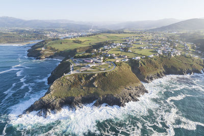 High angle view of sea and mountains against sky