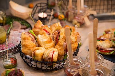 Croissant sandwiches with ham, iceberg lettuce, and tomato slices