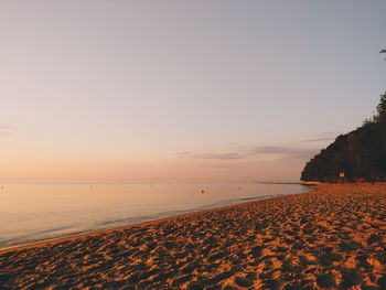 Scenic view of beach against sky during sunset