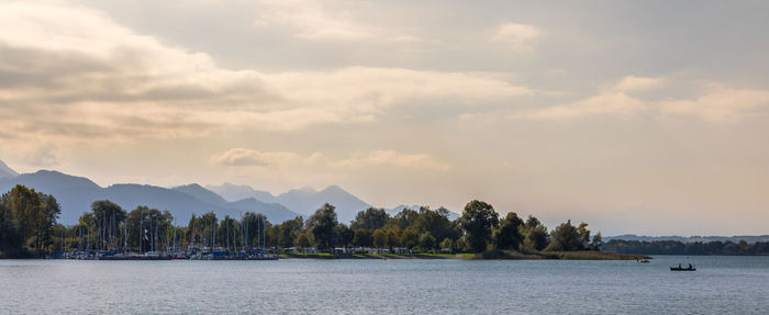 Scenic view of sea and mountains against sky