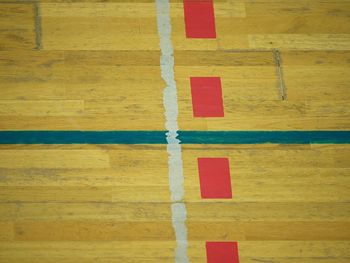 Worn out wooden floor of sports hall with colorful marking lines. schooll gym hall